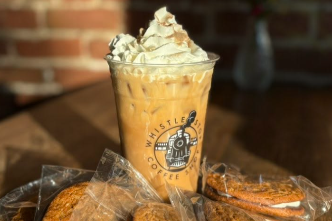 cup of iced coffee with whipped cream and oatmeal cream pies on table
